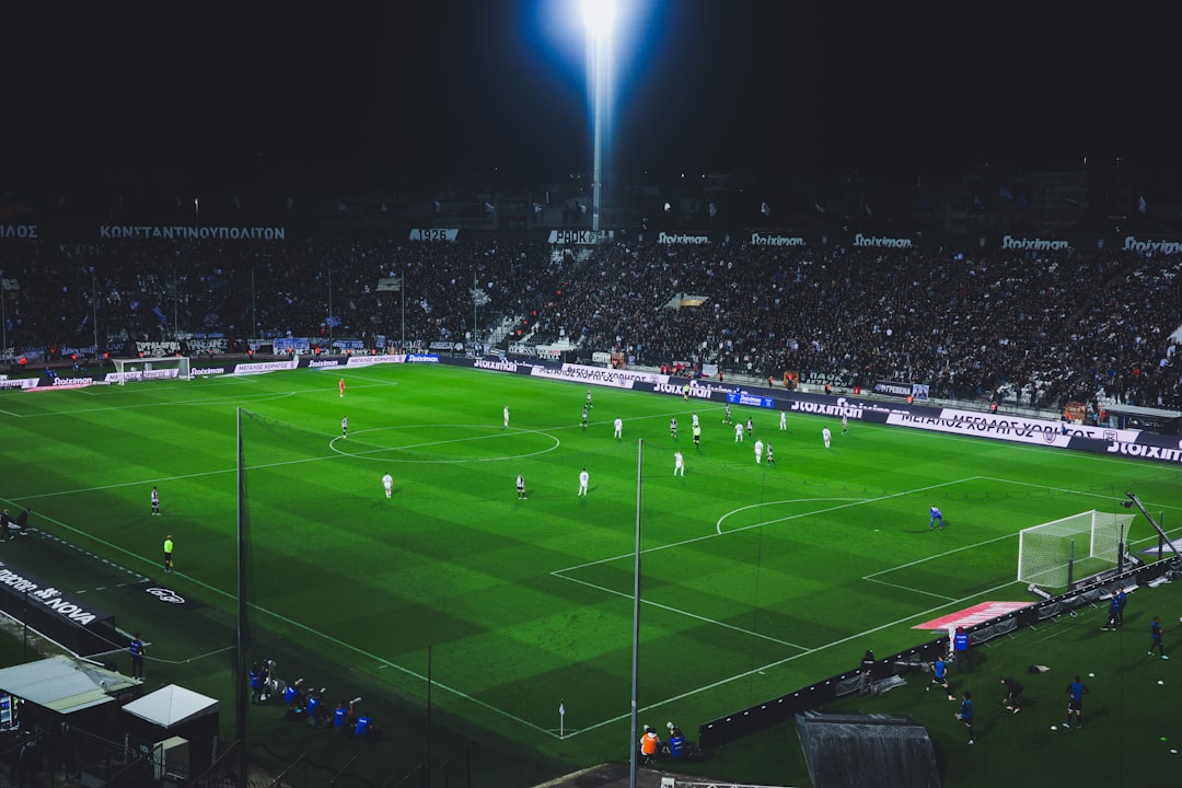 Soccer game illuminated by stadium lights at night. rayo vallecano defense, football match, la liga tactics