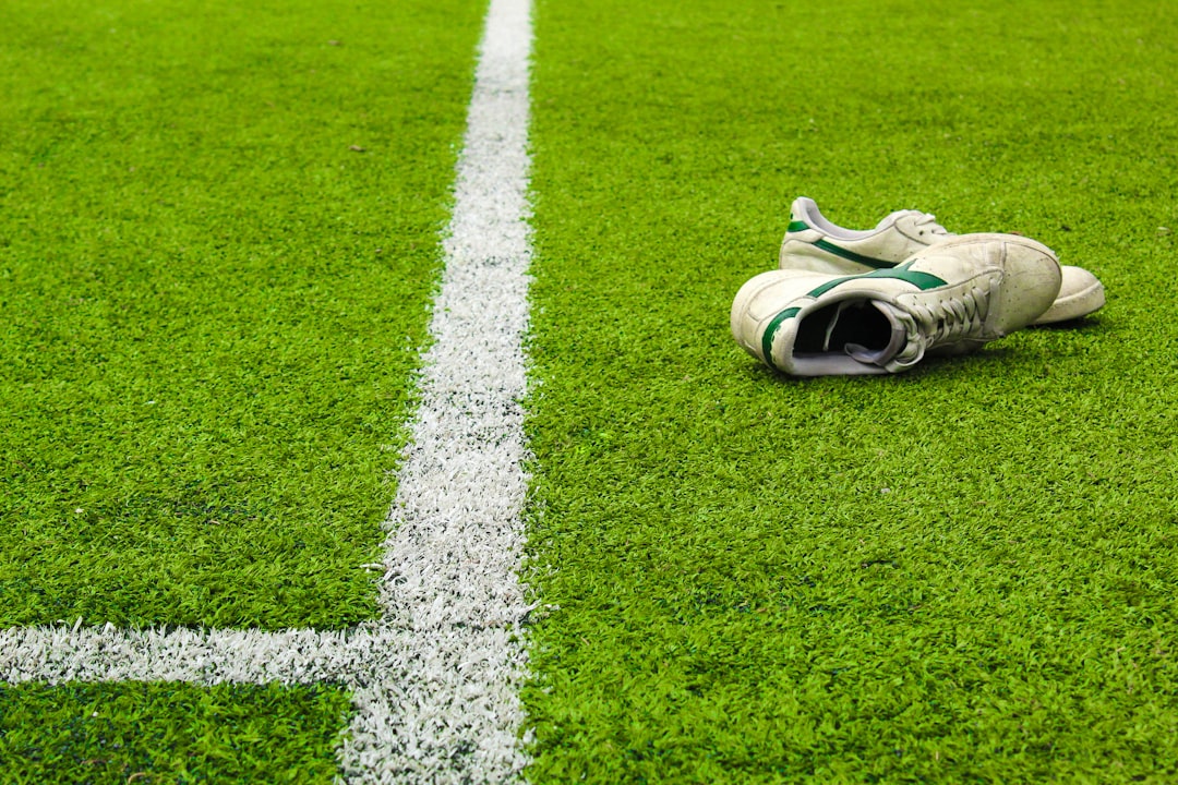 white and red nike sneakers on green grass field football onside kick, recovery, surprise