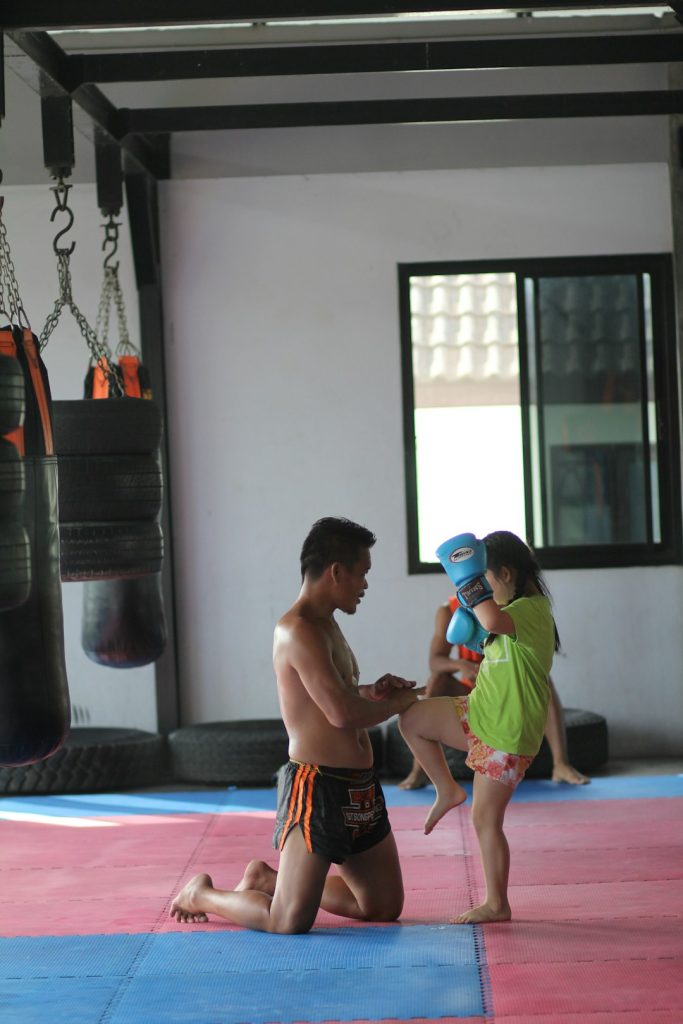 2 boys playing on purple mat muay thai training, sparring, martial arts gym