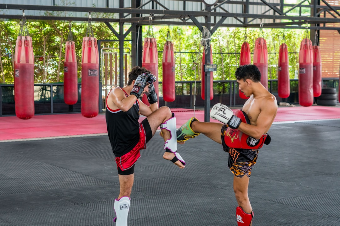A couple of men standing next to each other in a gym muay thai fighters, traditional training, thailand gym