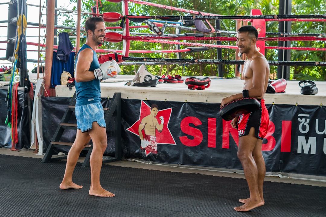 a couple of men standing next to each other muay thai fighters, traditional training, thailand gym