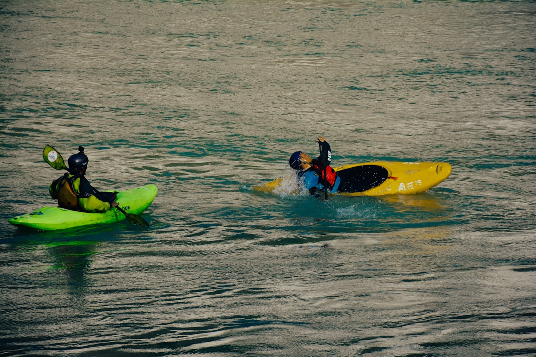 a couple of people riding on top of kayaks life jacket kayak safety river
