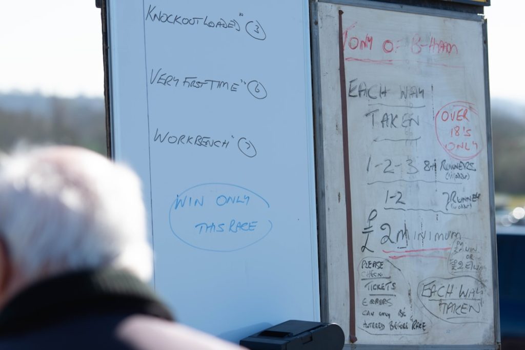 a man standing next to a white board with writing on it flag football strategy playbook drawing team practice