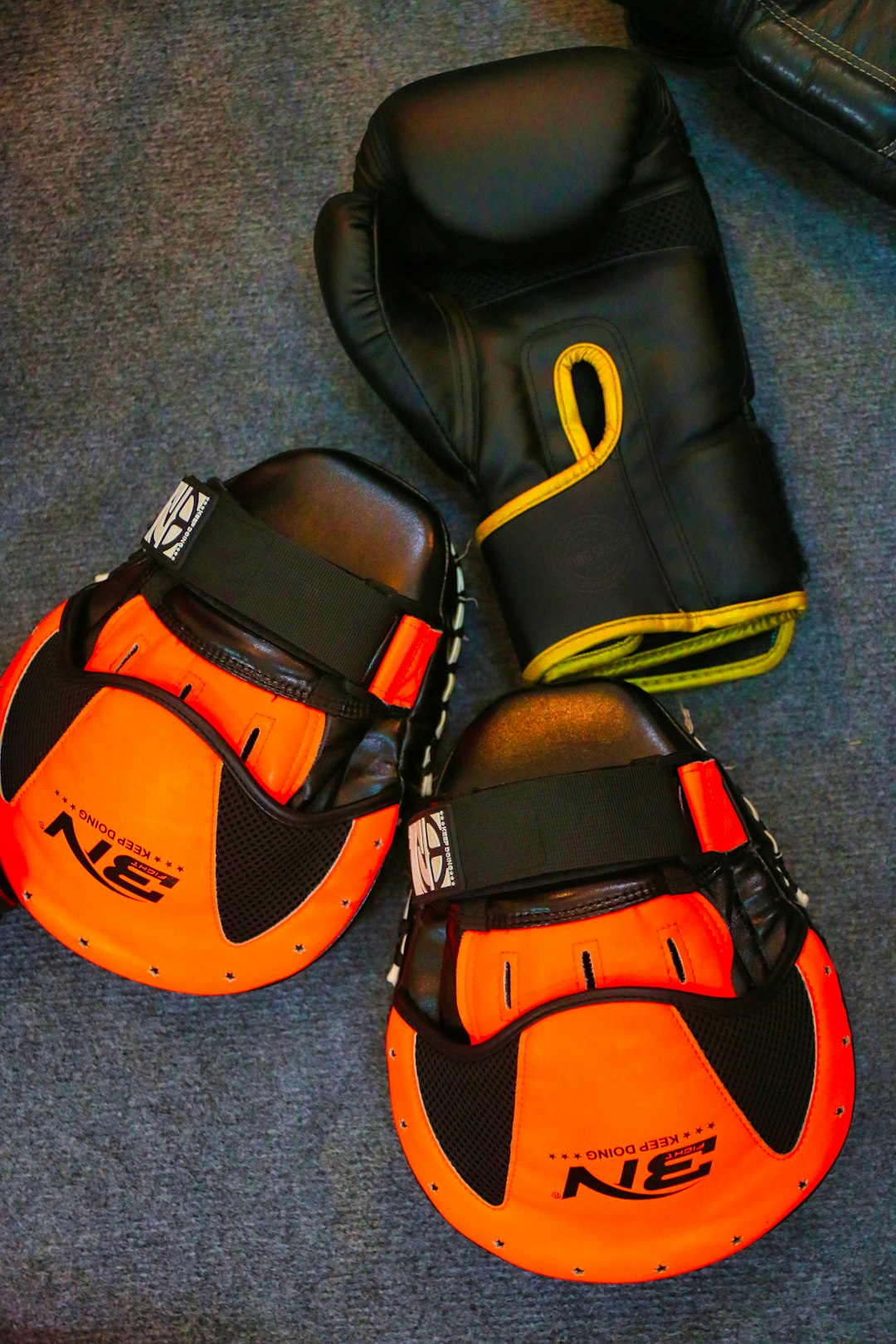 a pair of orange and black gloves and a pair of black and orange mitts kayak equipment checklist safety gear