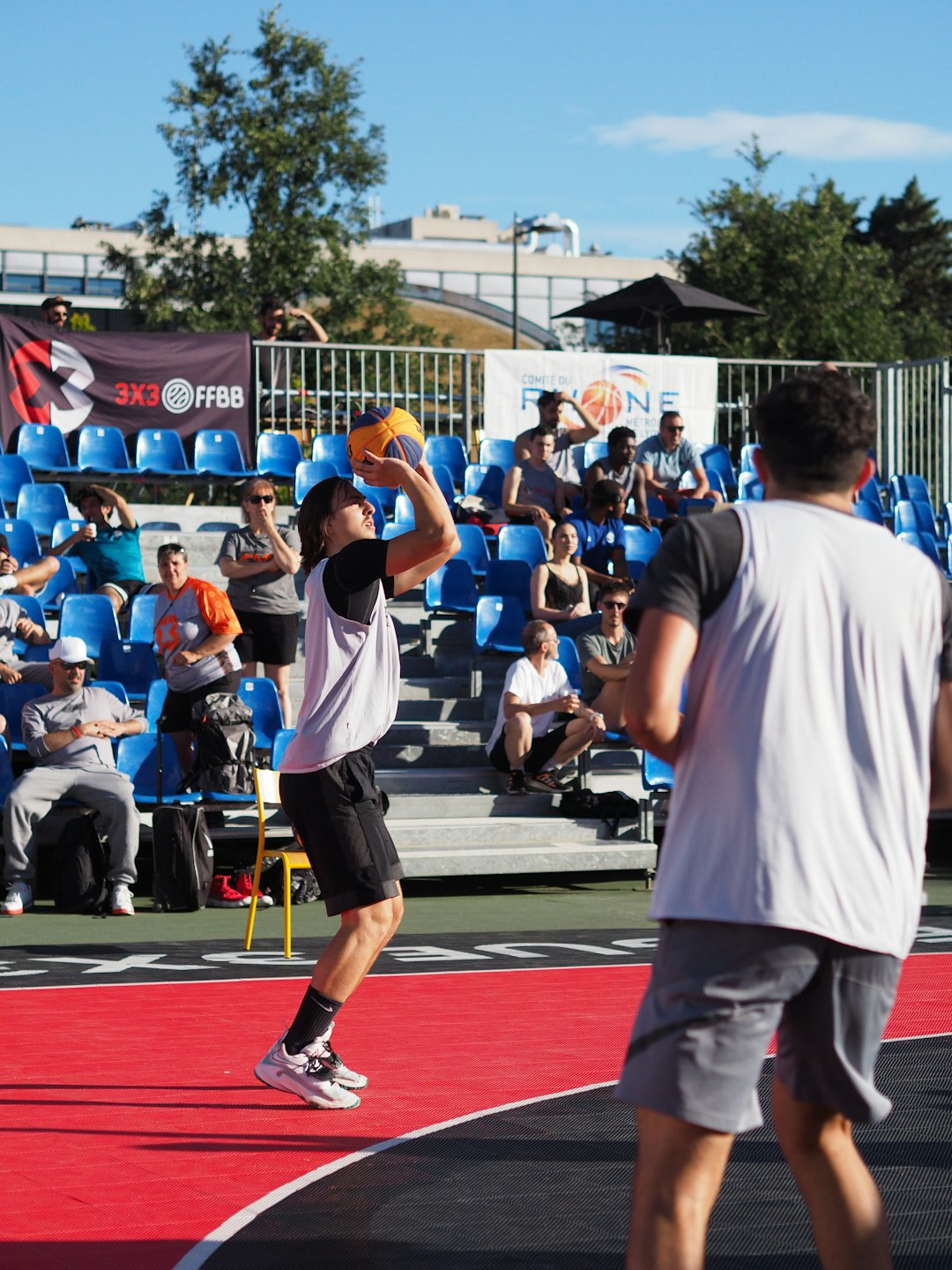 a person hitting a ball with a racket basketball court fans cheering