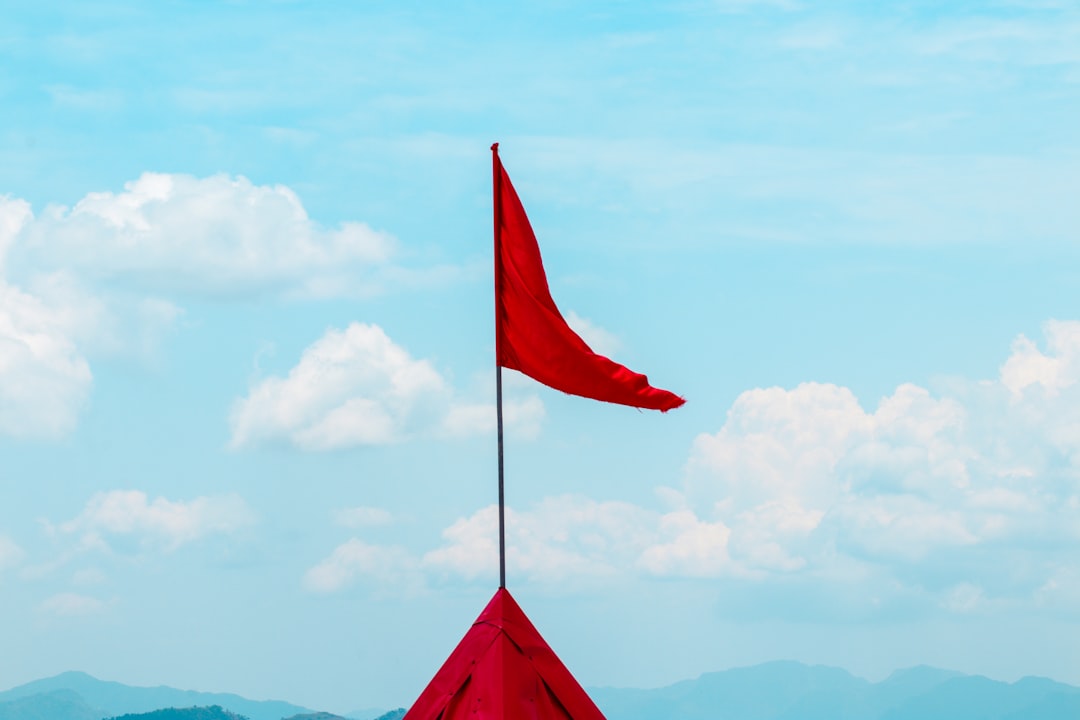 a red flag sticking out of the side of a building football practice coach training drills blue flag
