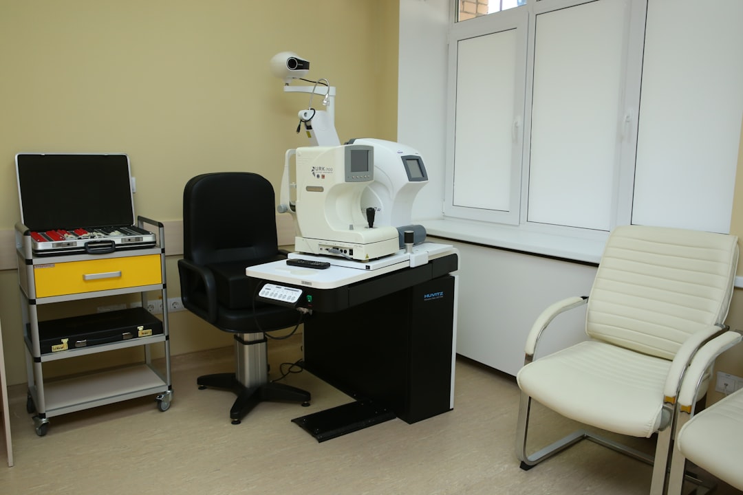 a room with a microscope and a chair clinic staff, happy client, laser treatment