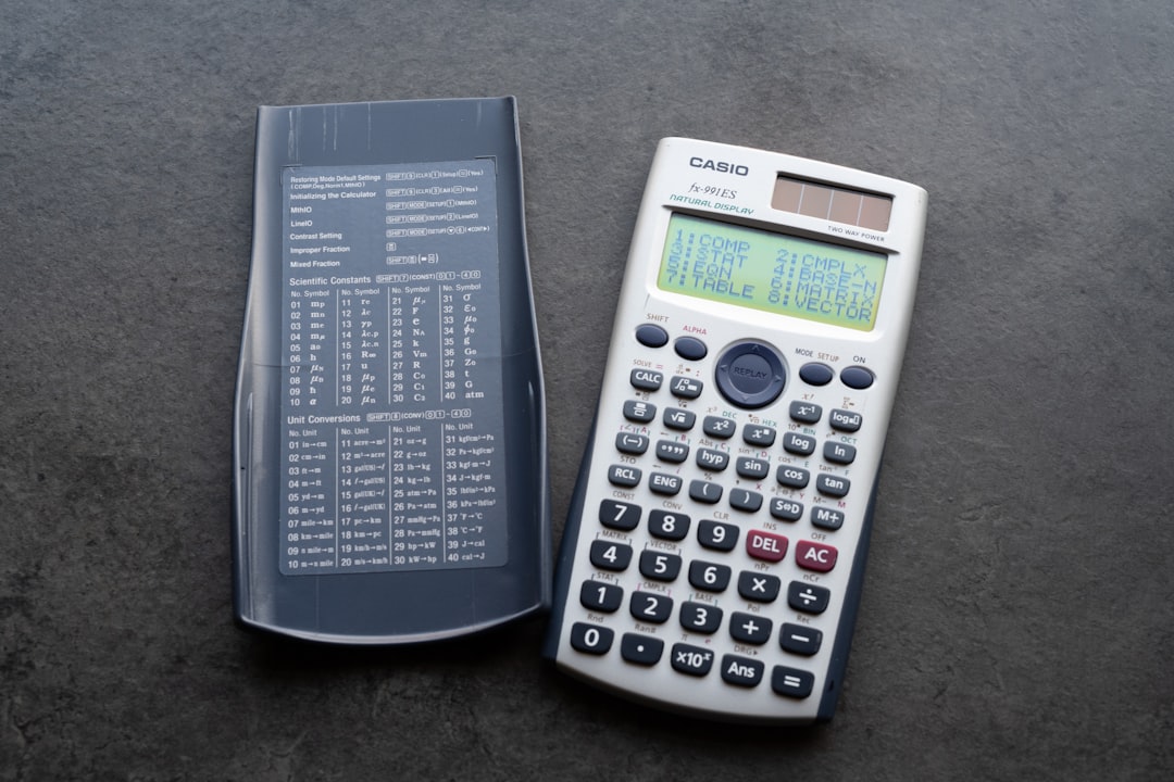 A scientific calculator with its cover open soccer money contract calculator