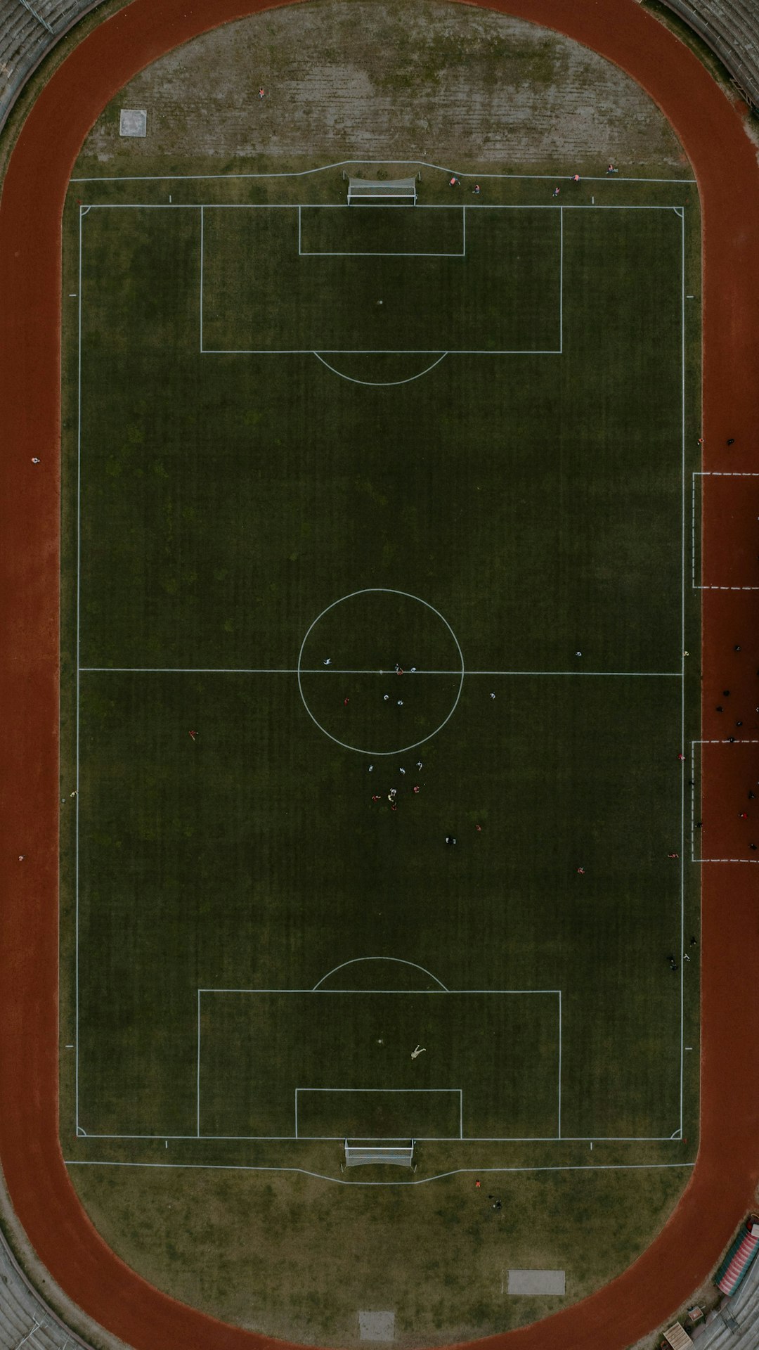 Aerial view of a football field with a running track. football positions, player lineup, chalkboard diagram