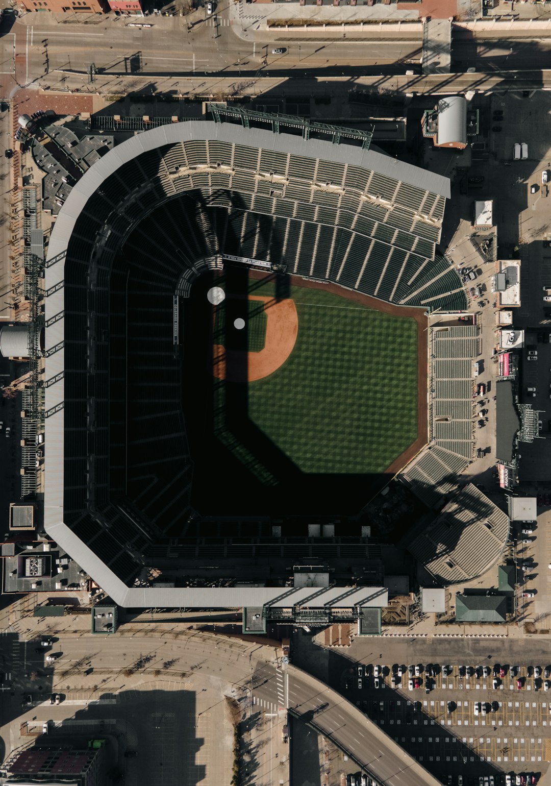 An aerial view of a baseball stadium. baseball stadium aerial view, sunny day game, crowd in stands
