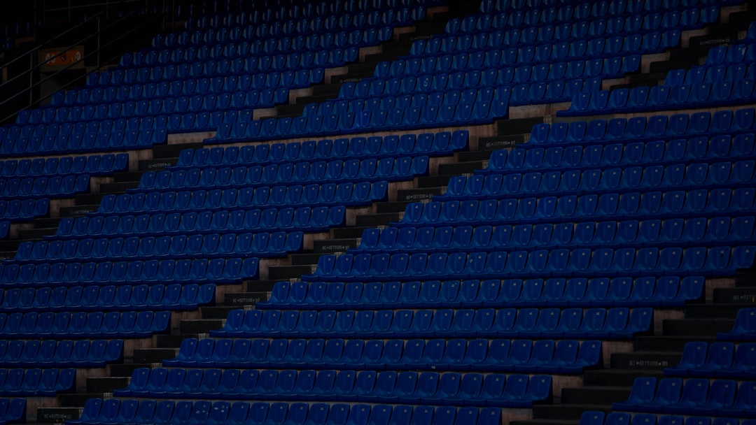 Empty blue stadium seats in rows empty seats, struggling hockey team, arena issues