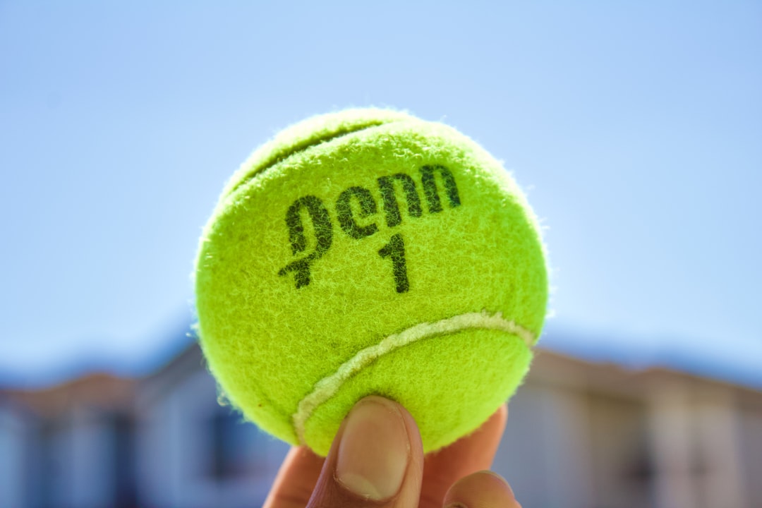 green tennis ball on hand next gen, challenger tour, tennis training, young tennis players