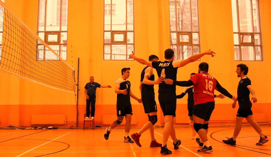 group of men playing basketball teamwork volleyball positions indoor court