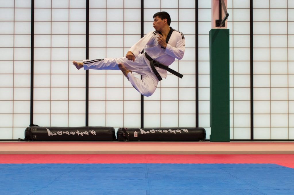 man doing karate stunts on gym middle blocker jump block timing