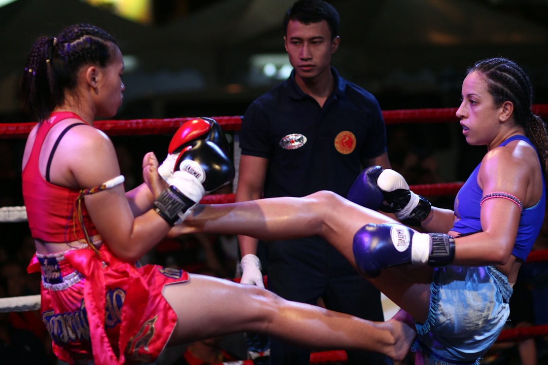 man in blue jersey shirt holding white and blue soccer ball muay thai, thailand, traditional fight