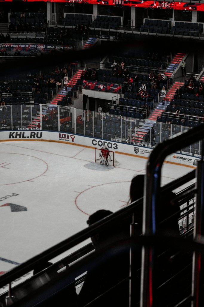 people playing ice hockey inside stadium empty seats, struggling hockey team, arena issues