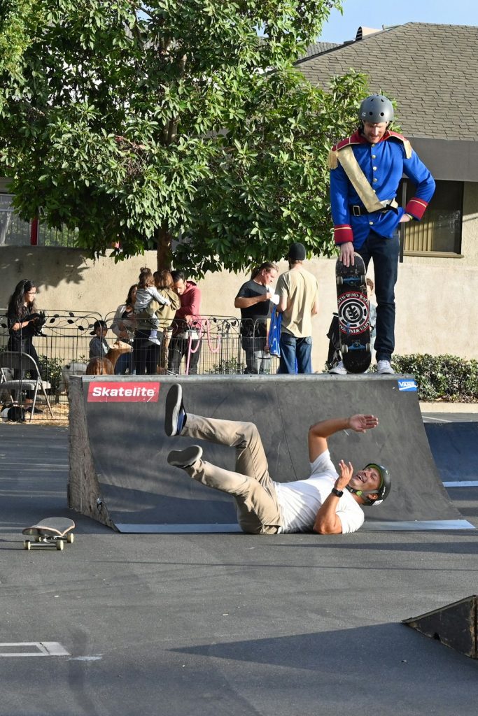 person playing skating lying on ground during daytime freestyle bmx street park trick