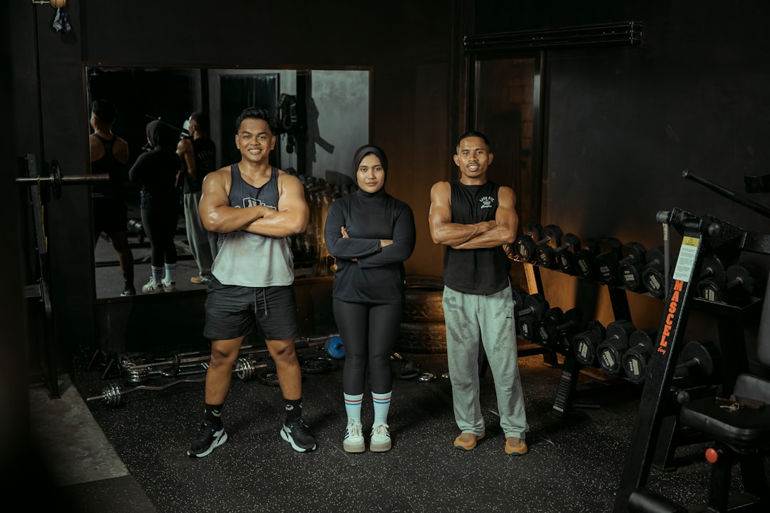 Three people pose at the gym. inclusive fitness diverse gym people
