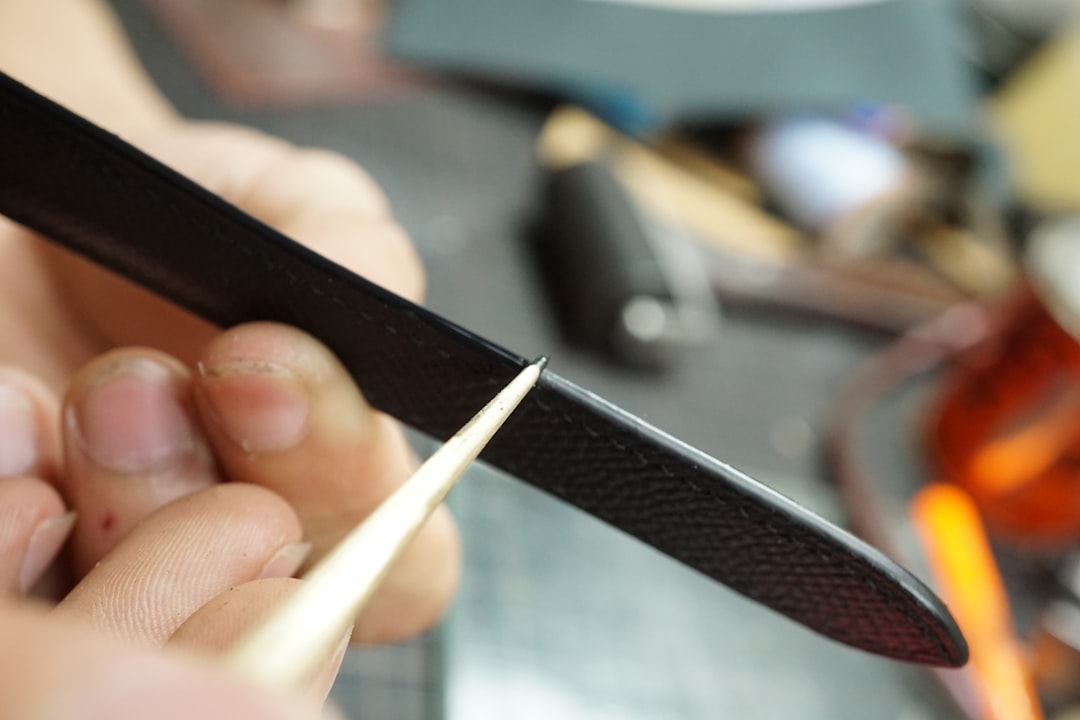 a close up of a person cutting a piece of metal vinyl stylus closeup, cleaning stylus, needle care