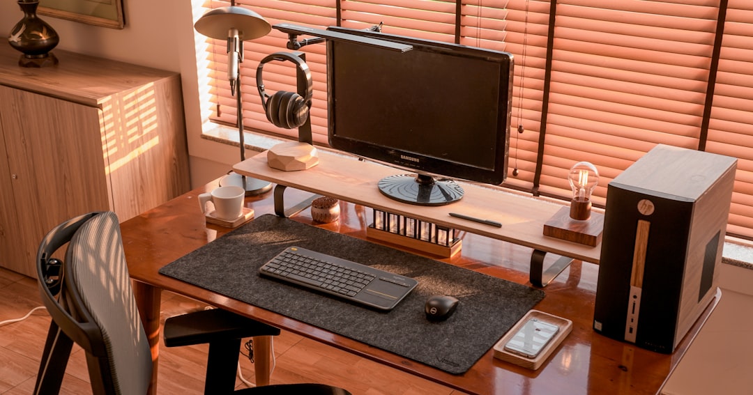 a computer desk with a monitor, keyboard and headphones gaming setup, office accessories, monitor mounts
