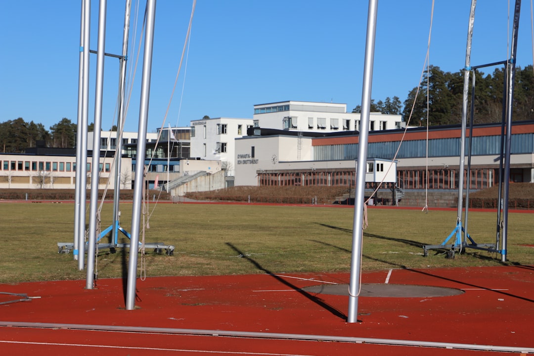 a field with a building in the background girls sports high school track