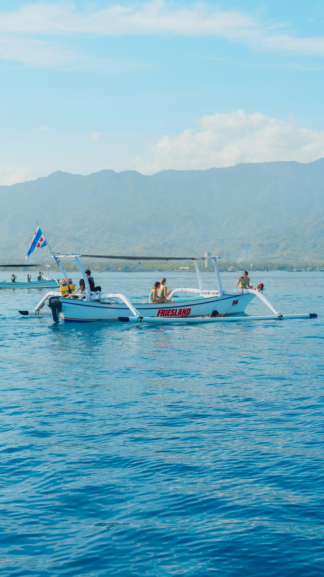 A group of people on a boat in the water pontoon boat, wakeboarder, water sport