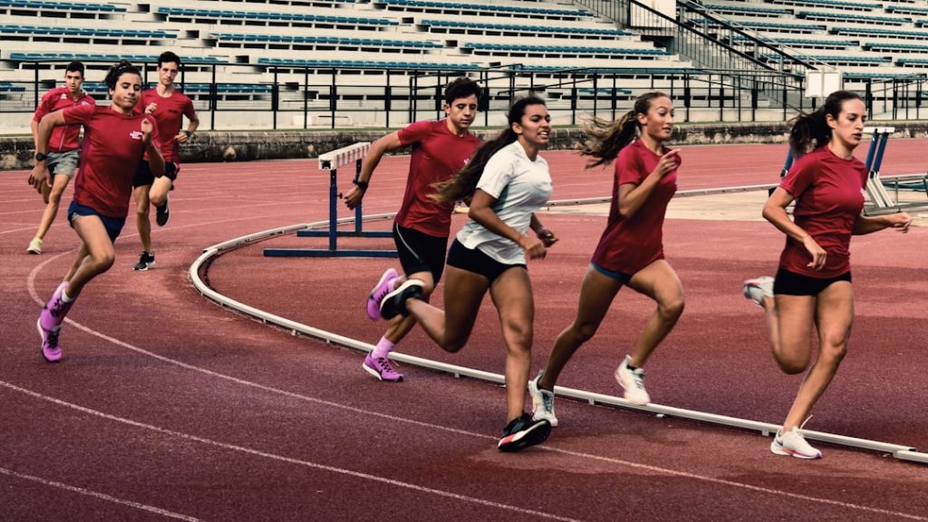 a group of people running on a track female athletes empowerment equality