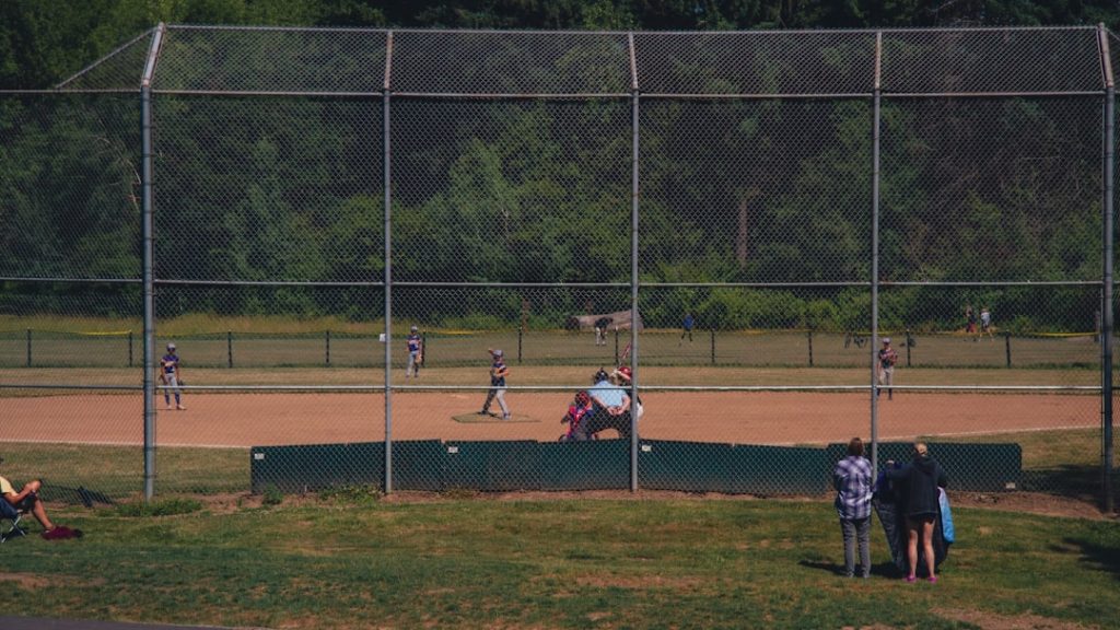 a group of people standing on top of a baseball field paintball field players action