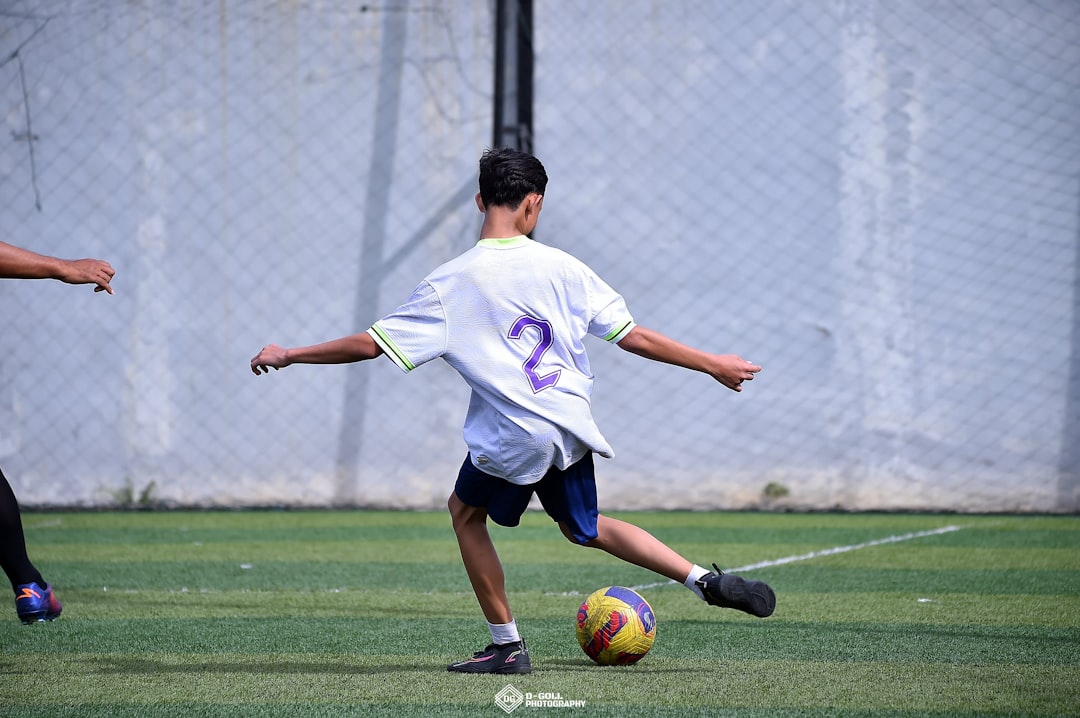 A group of young men playing a game of soccer through ball, forward pass, defense split, soccer pass