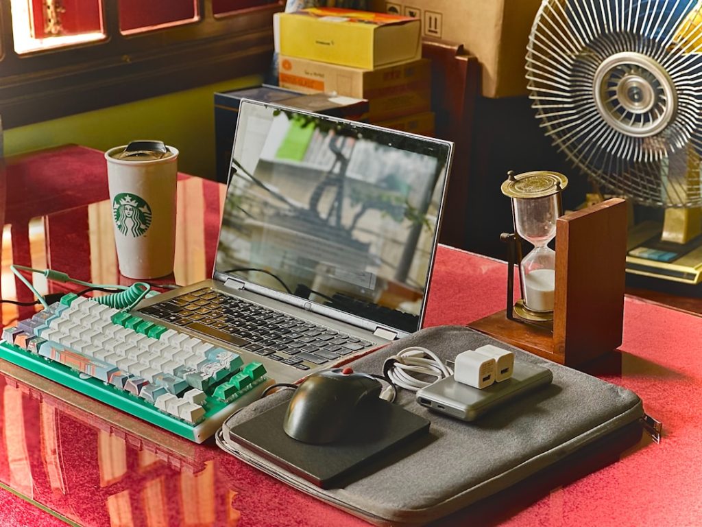 A laptop computer sitting on top of a desk gaming setup, office accessories, monitor mounts