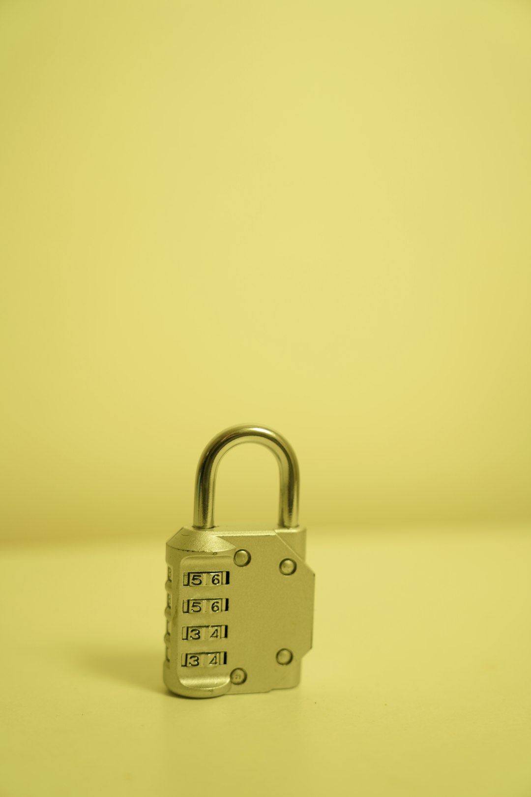 a padlock on a table with a yellow background security checklist backup codes safe login