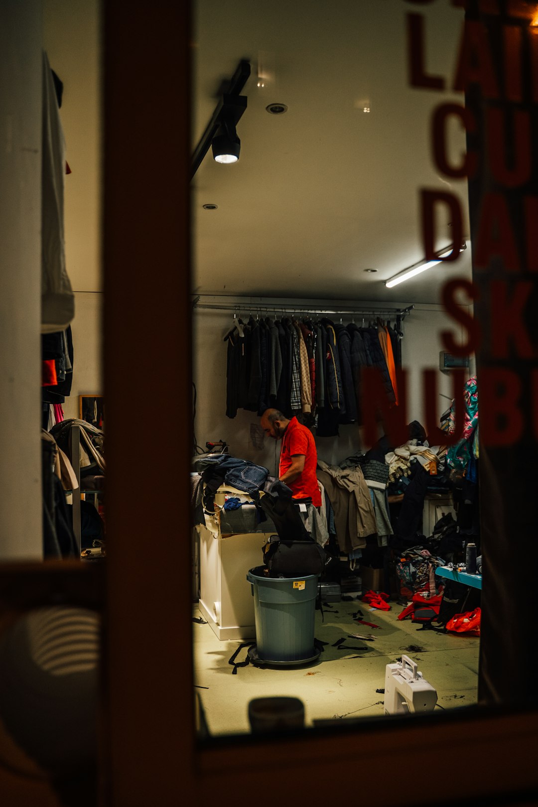 a person standing in a store football gear fitting, player trying vest, locker room