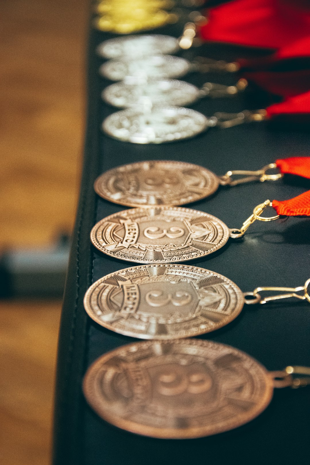 a row of coin key chains on a table podium, bodybuilding, medals