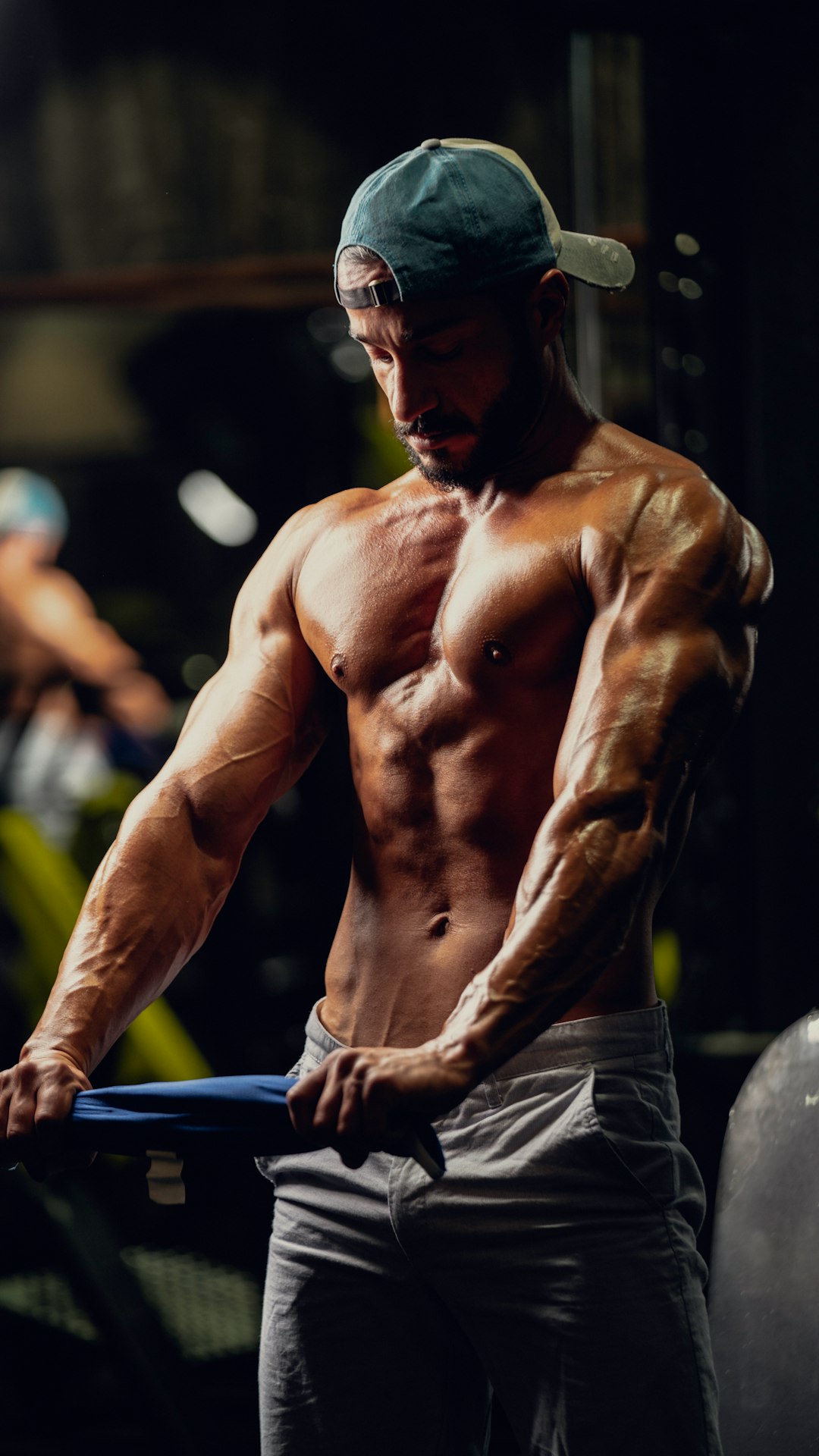 a shirtless man holding a bar in a gym bodybuilder, steroids, syringe