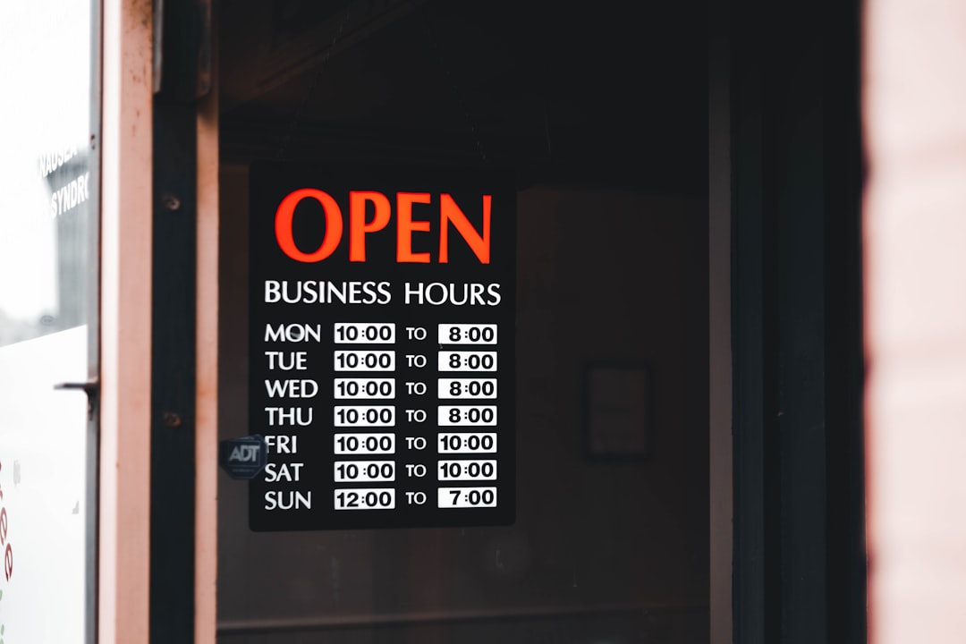 a sign on a door that says open business hours google business profile optimization storefront signage
