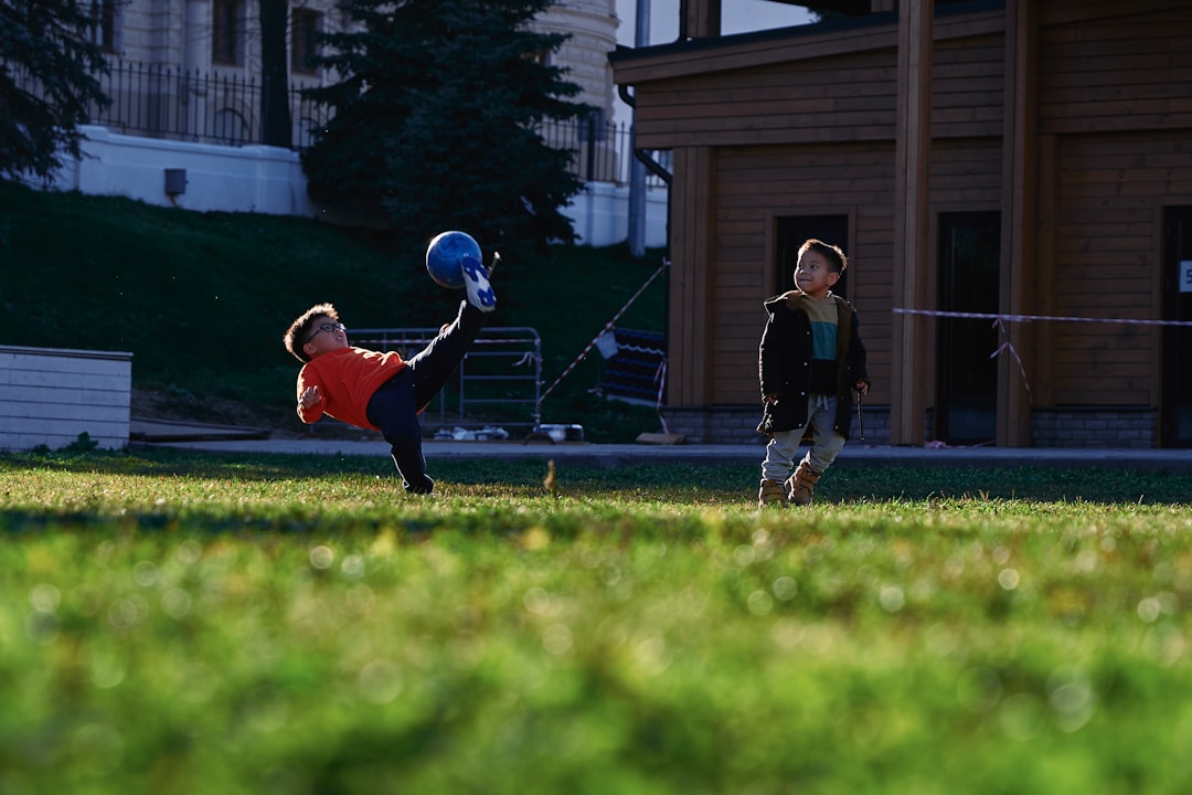 a small child swinging a bat at a ball youth lacrosse, practice session, soft balls