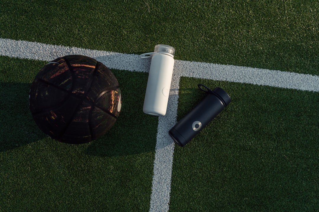 a soccer ball and a water bottle on a soccer field soccer training equipment, smart soccer ball, video analysis