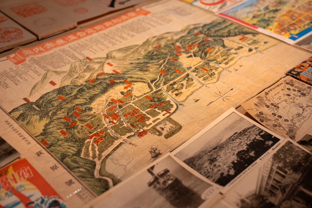 An old map with photos and books surrounding it. panorama, timeline, infographic carousel