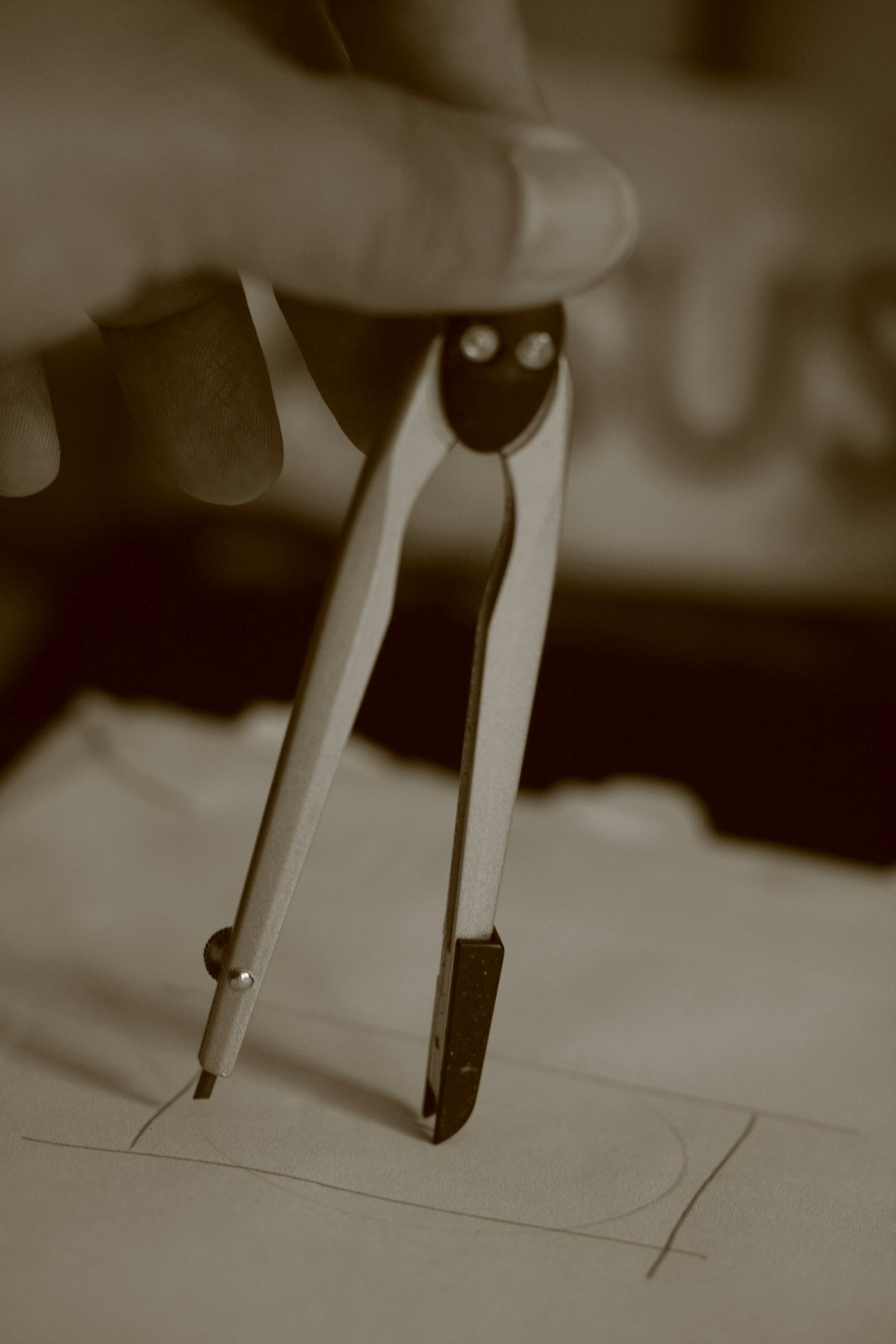 gray scale photo of person holding paper clip vinyl stylus closeup, cleaning stylus, needle care