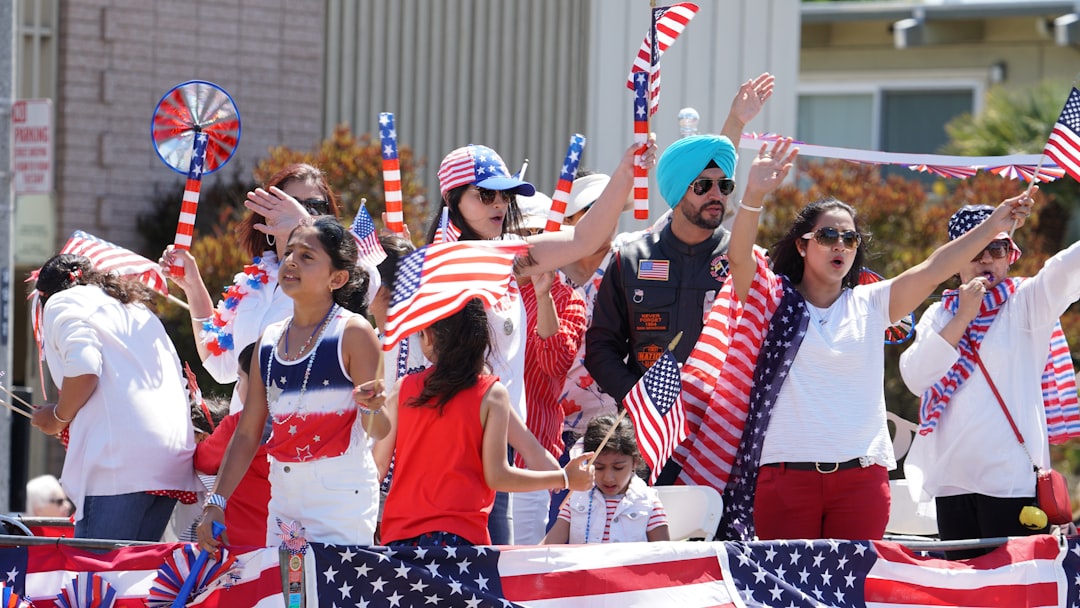 people holding an America flag during daytime sports fans, celebrating, diverse groups