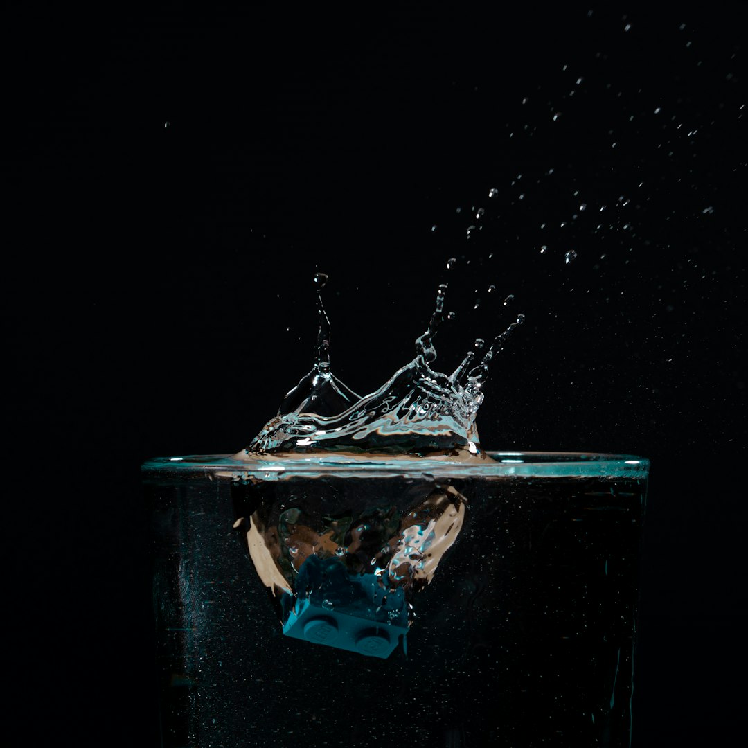 person in blue water in water wakesurfer trick balance spin motion water