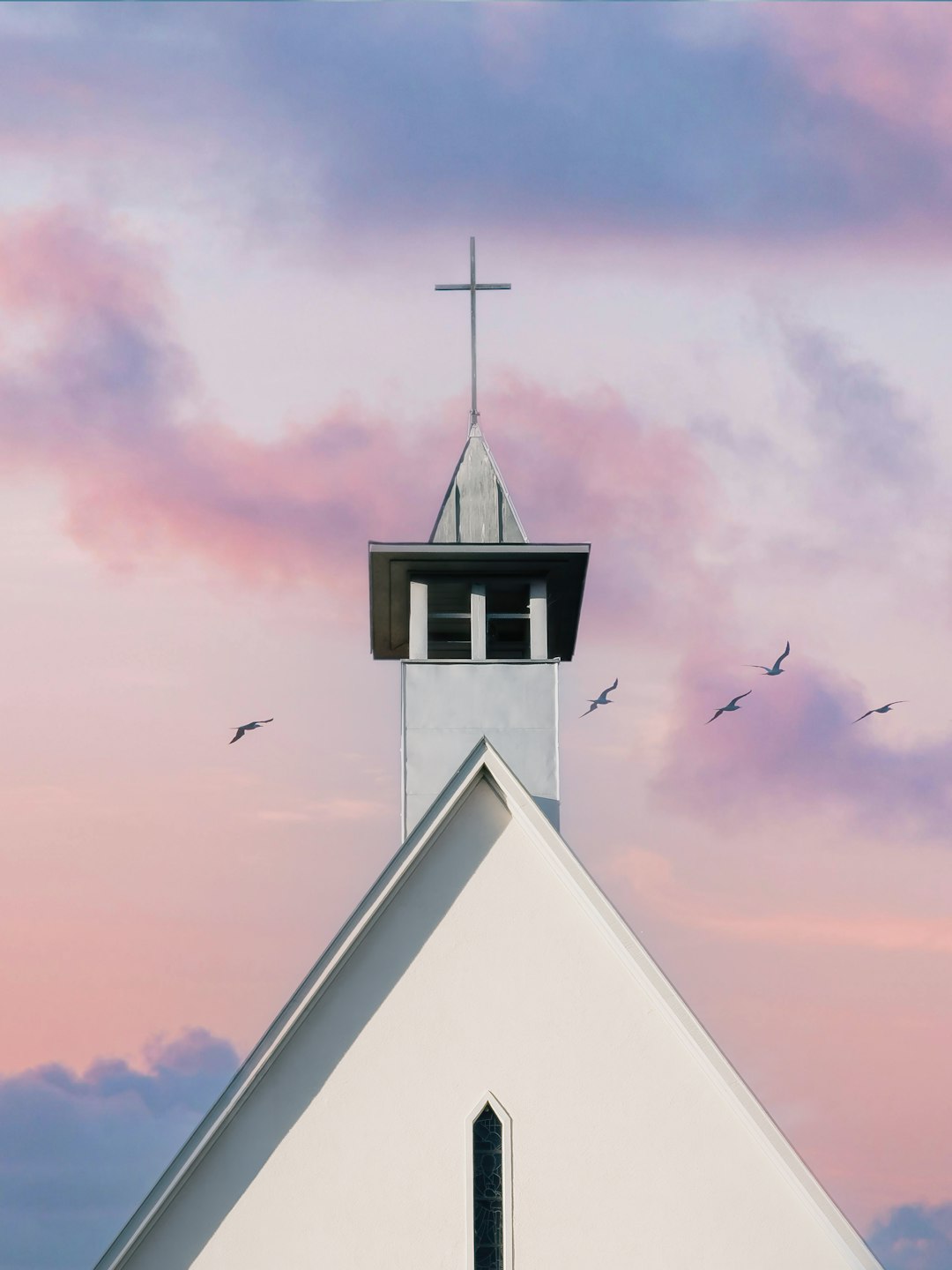 White church steeple against a pastel sky with birds. church website, religious theme, wordpress design