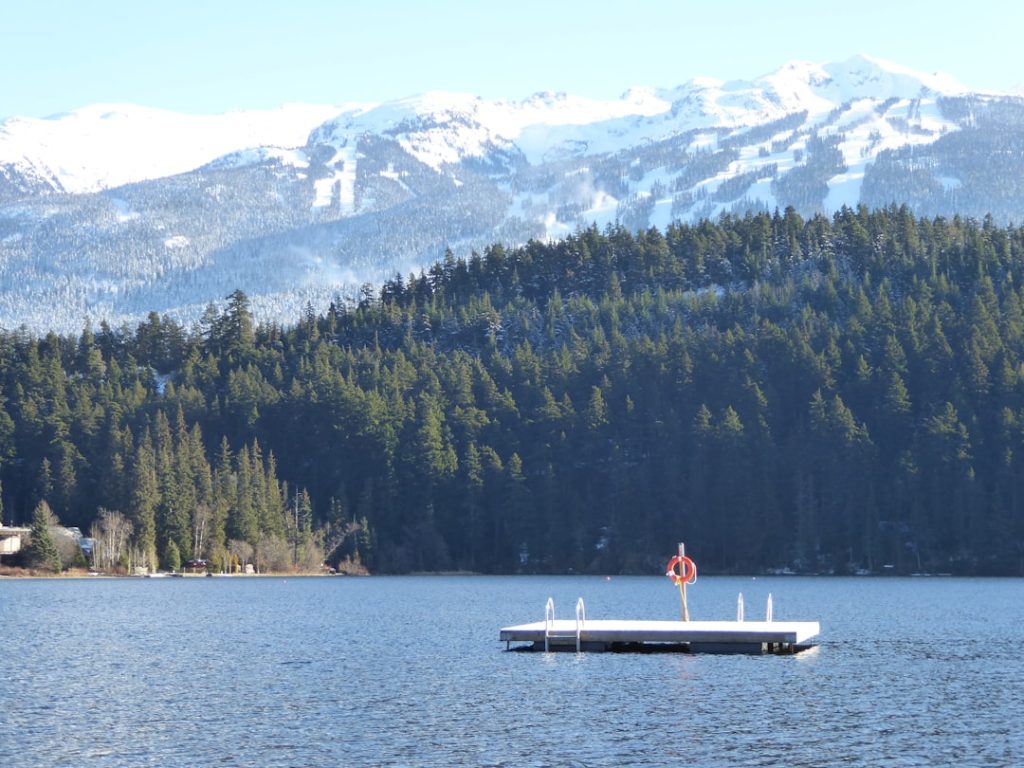 white wooden dock calm lake water skiing safe location boat