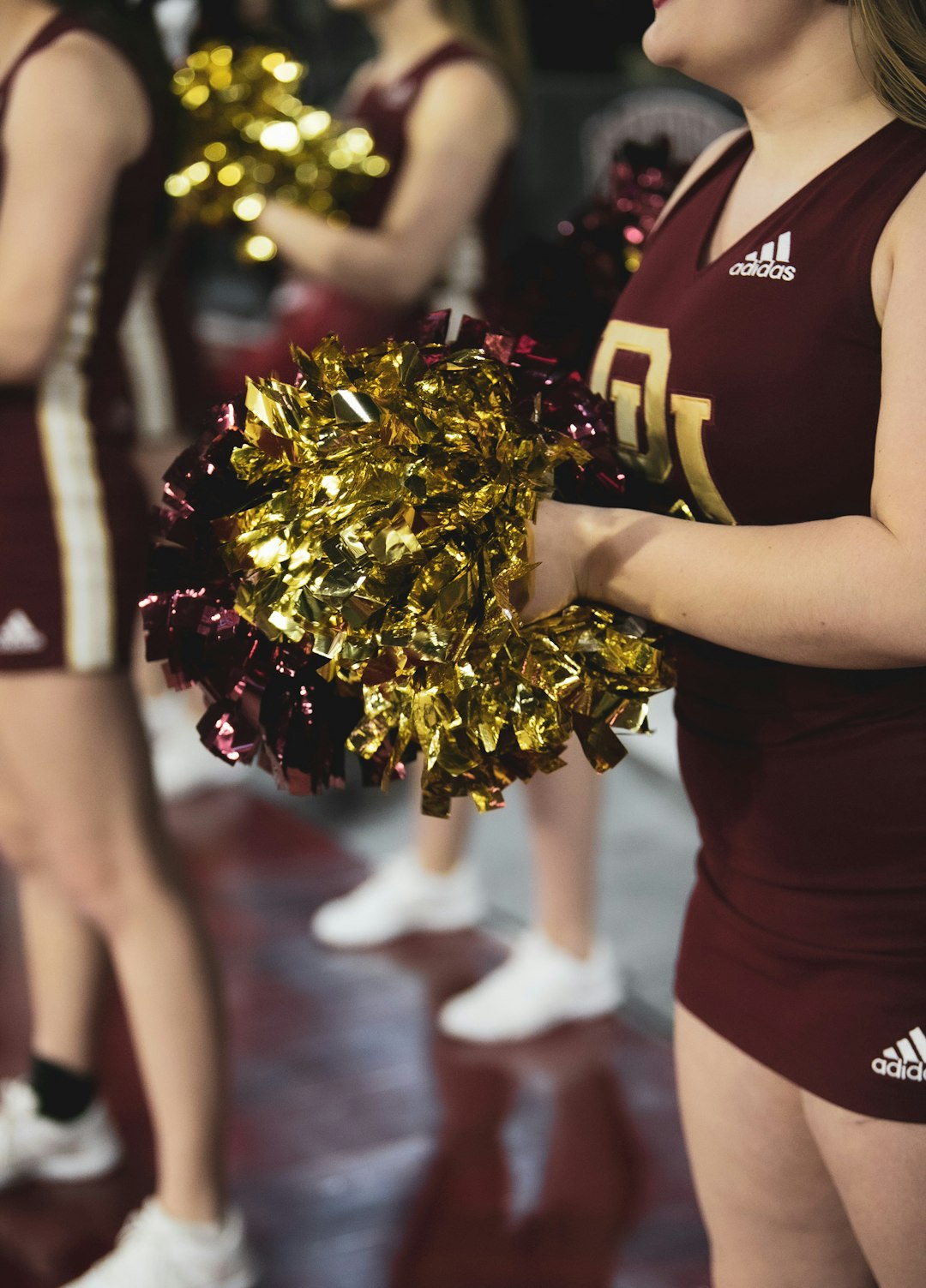 woman in black shirt holding bouquet of flowers college sports gender equity audit