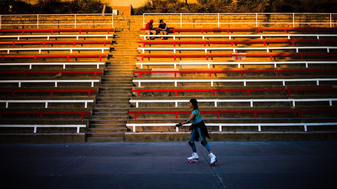 woman playing roller skates high school football fans bleachers night game