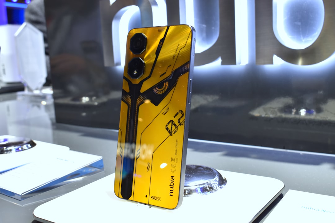 Yellow smartphone with futuristic design and camera lenses nubia neo2 full view, gaming accessories, budget phone setup