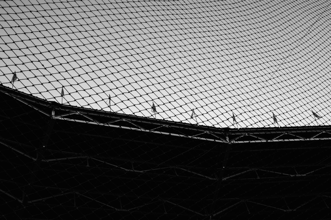 a black and white photo of a tennis court net reds orioles baseball elly de la cruz santander