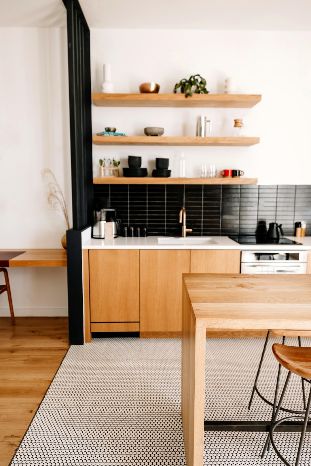 a kitchen with a wooden table and black tile backsplash home decor minimalist kitchen fashion lifestyle
