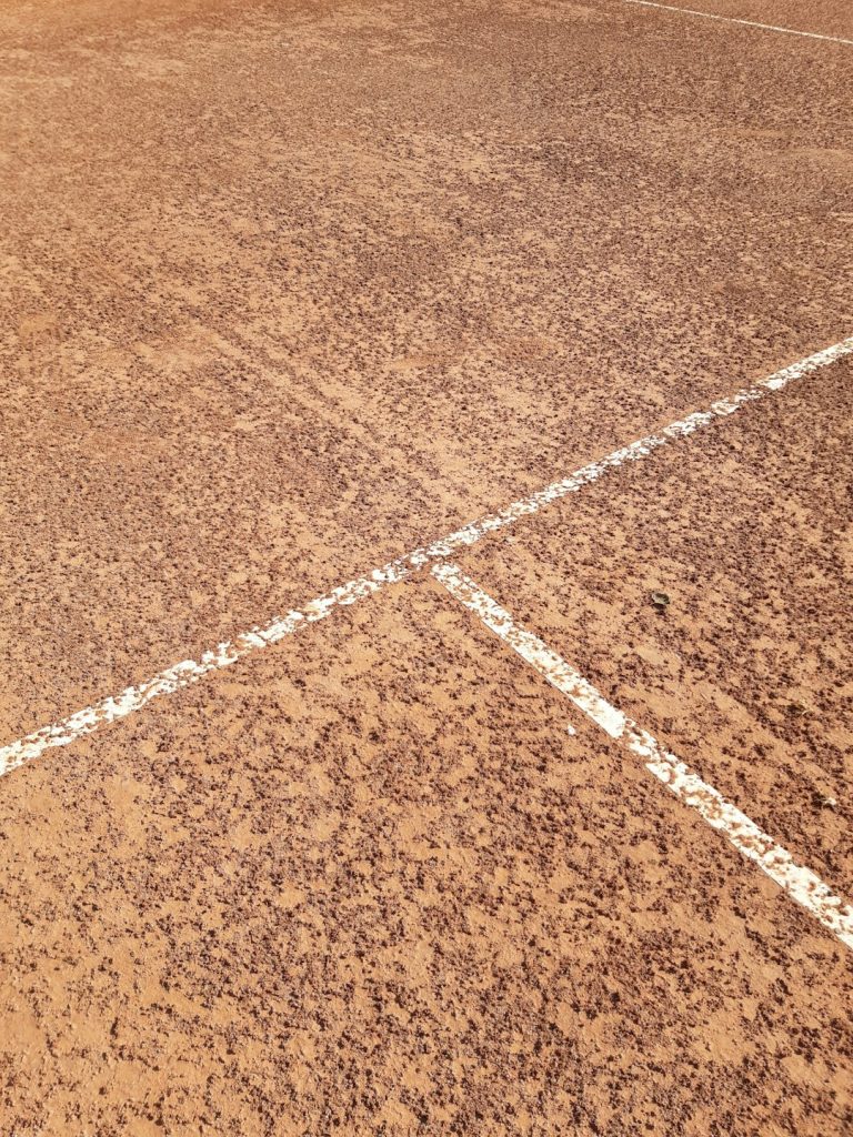 a man holding a tennis racquet on top of a tennis court reds orioles baseball elly de la cruz santander
