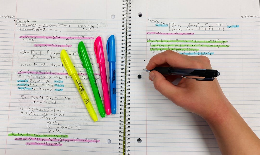 a person writing on a notebook with colored pens tablet highlight pdf exam prep student notes